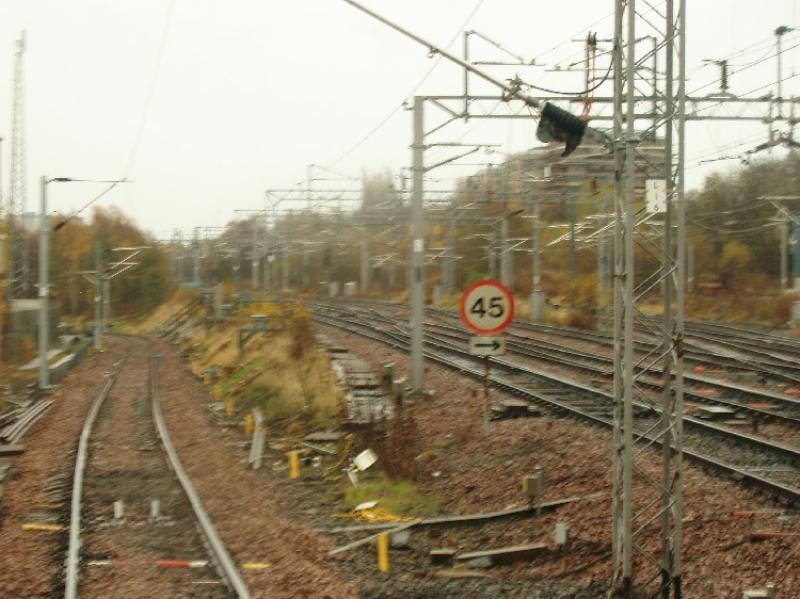 burma13.jpg: Descending the Burma Road, with new electrification masts being erected. Photo of burma13.jpg