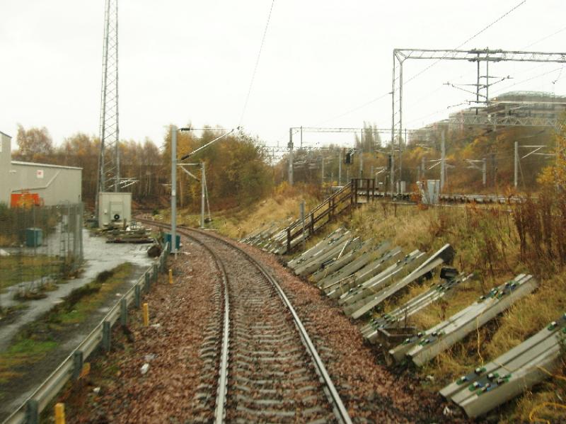 burma14.jpg: Descending the Burma Road. A new radio mast has also been built, while new concrete sleepers are alongside the track ready for installation. Photo of burma14.jpg