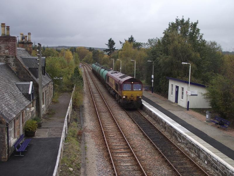 Lairg tanks near journey's end.: 66104 runs into Lairg station to run-round 6H03, the 09:22 Inverness - Lairg oil tanks on 15/10/2011. Photo of Lairg tanks near journey's end.