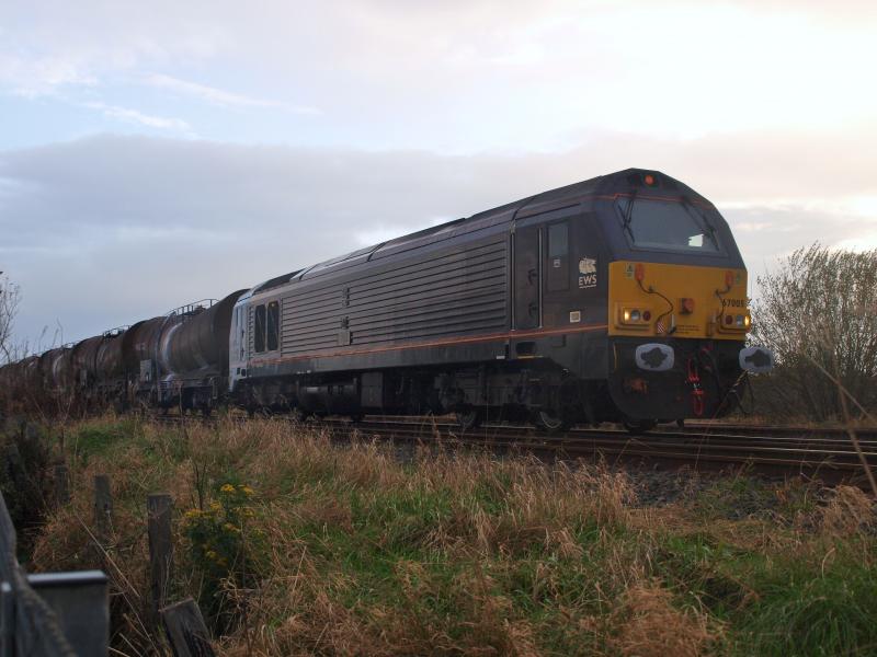 Barassie - 03-11-2011: DB Schenker 67005 waits in Barassie Yard (the remains of the Troon avoiding line) with 17 empty china clay tankers from the Caledonian Paper Mill, Irvine, returning to Mossend Yard. Photo of Barassie - 03-11-2011