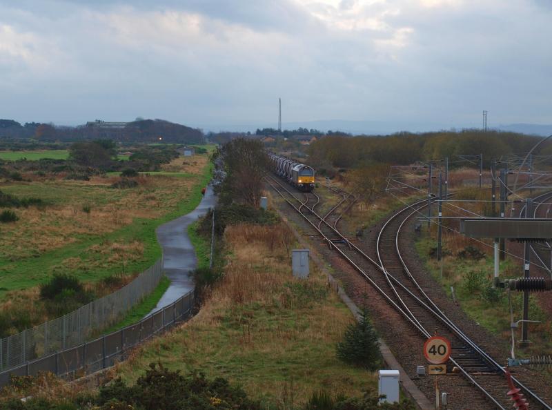 Barassie - 03-11-2011: DB Schenker 67005 waits in Barassie Yard (the remains of the Troon avoiding line) with 17 empty china clay tankers from the Caledonian Paper Mill, Irvine, returning to Mossend Yard. Photo of Barassie - 03-11-2011