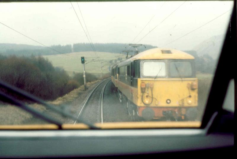 On test: One test passes another; taken at Harthope in February 1991 from 91024 on a pre ECML Carlisle to Polmadie test passing 87032 KENILWORTH and cover loco on the conditional Mossend to Carlisle ex-Works test run. Photo of On test