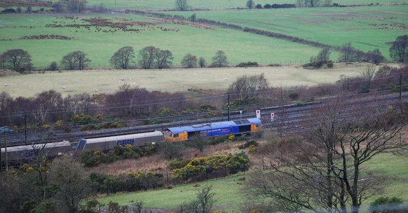 66719 @ Hunterston: 66719, @ Hunterston, sits at the stop boards before proceeding to be loaded
Meanwhile 66044 propelles its train thru the loading tower Photo of 66719 @ Hunterston