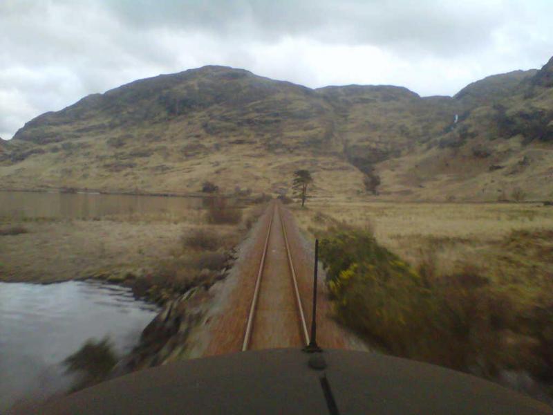 Drivers view of Loch Eilt: A view from the cab of 37059 crossing the back of Loch Eilt just after the causeway on a ballast returning from Arisaig. Photo of Drivers view of Loch Eilt