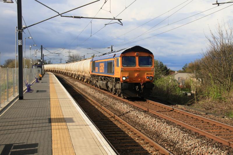 Alcans at Newcraighall: 66735 on 6E45 08.13 Fort William to North Blyth pasing through a sunny Newcraighall on 11/04/2011. It is getting hard to get a freight without a unit in the way. Photo of Alcans at Newcraighall