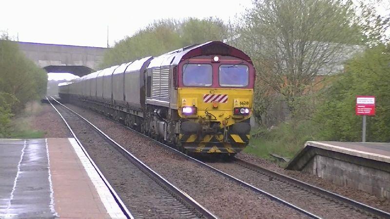 66218 at Carmyle 24-04-12: DBS Eurocargo Rail 66218 approaches Carmyle station in pouring rain with 4J09 Longannet to Hunterston empty HTA hoppers. 24 April 2012. Photo of 66218 at Carmyle 24-04-12
