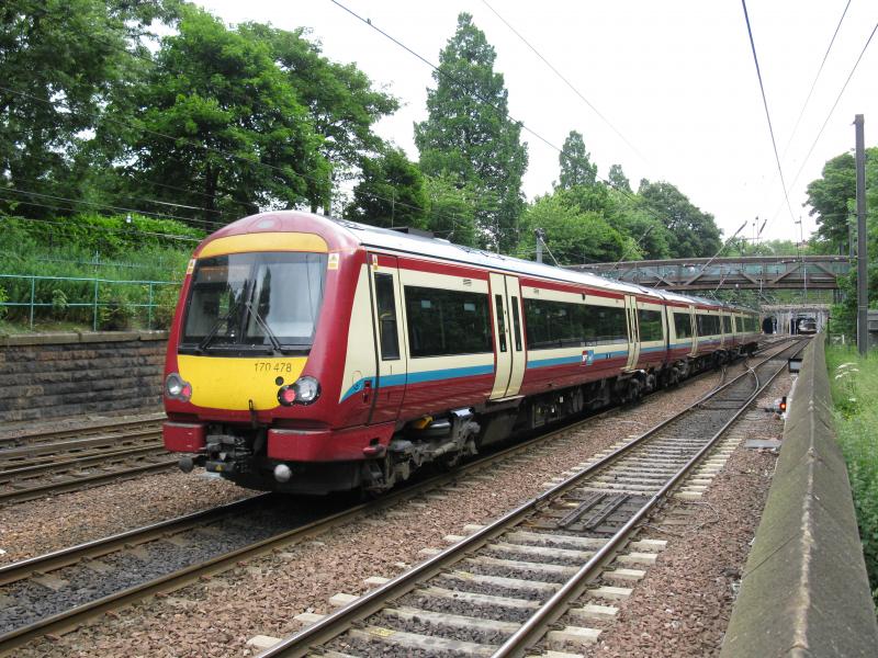 Class 170: Class 170 at the foot of Edinburgh Castle mound in SPT livery. Photo of Class 170