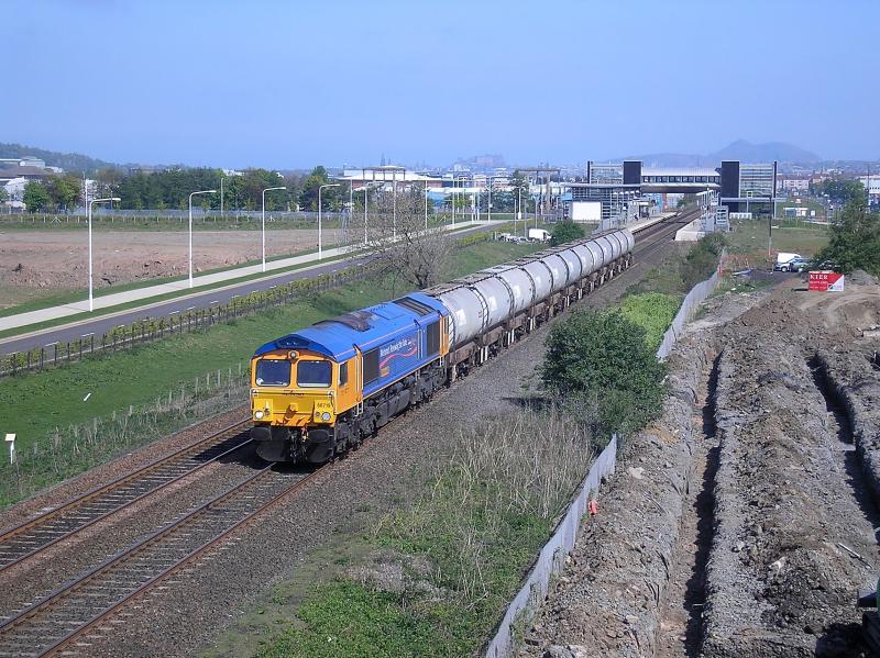66719: Metronet liveried 66719 is seen a long way from home as it passes through Edinburgh Park on 01.05.07, while working the 6S60 Harwich - Aberdeen loaded Mud Oil tanks. Photo of 66719