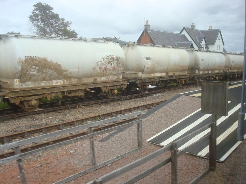 Damaged Alumina Wagons at Corrour: Some of the damaged Alumina wagons at Corrour sidings yesterday (12/7/12). At least a couple have ruptured tanks. All appear to have damage to buffers and couplings. Photo of Damaged Alumina Wagons at Corrour