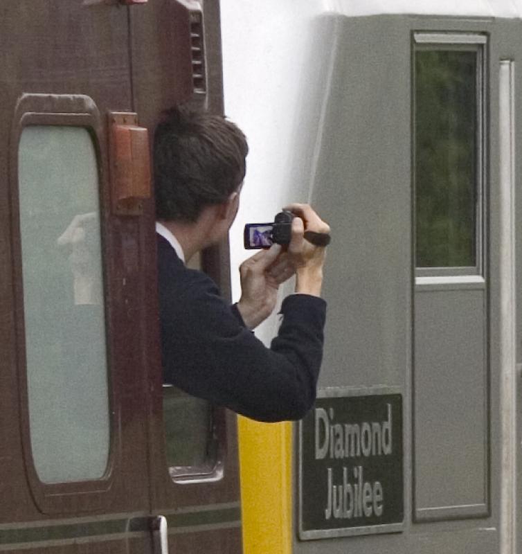 Over the shoulder photography: An avid videographer takes in the delights of a silver skip and a red bridge on 28th June 2012. Photo of Over the shoulder photography