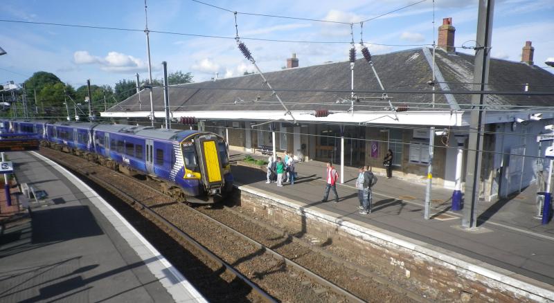 Kilwinning Station: An evening arrival from Glasgow eagerly awaited by passengers at Kilwinning Station on a bright July evening. Photo of Kilwinning Station
