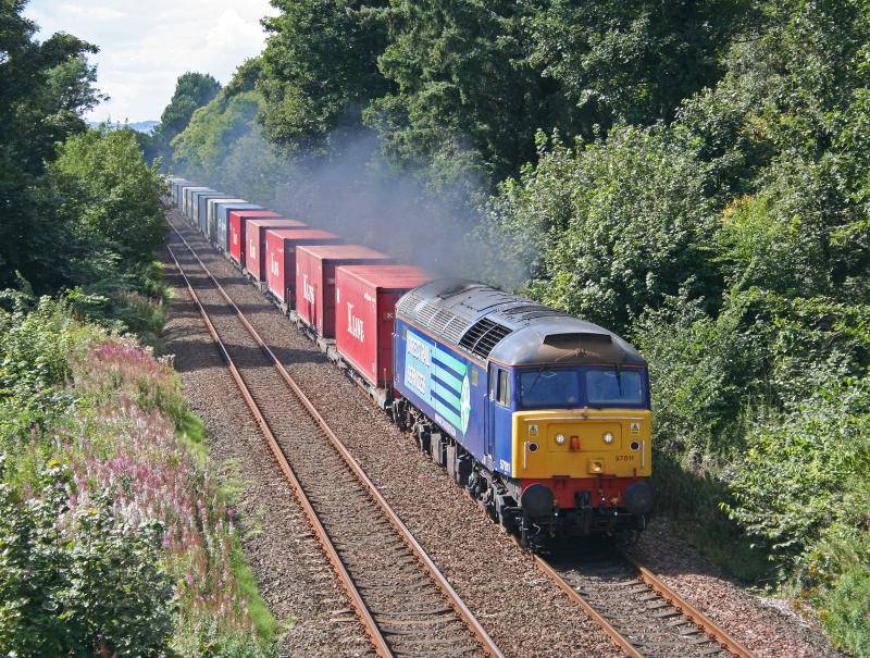 57011 4A13 190810 Kingoodie:
57011 screams through Kingoodie on the first day of operation using DRS 57's on the Aberdeen intermodal 19th August 2010 Photo of 57011 4A13 190810 Kingoodie