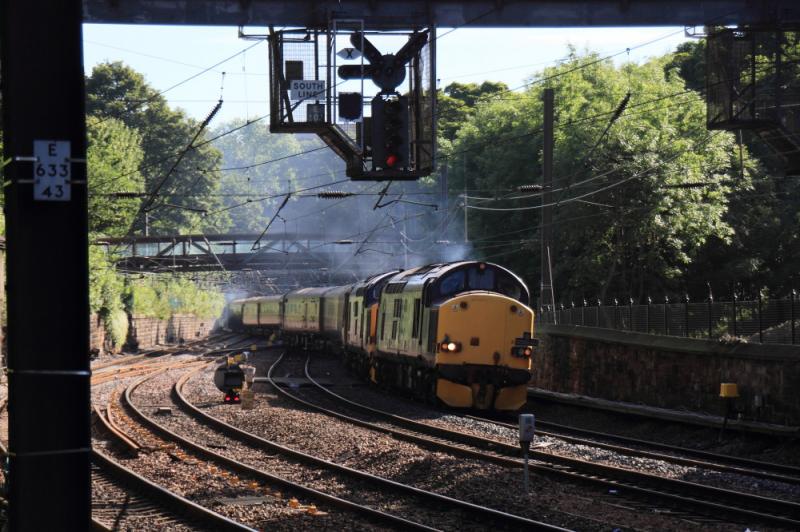 Norhern Belle 1Z39: 37602 + 37423 on 1Z39 09.29 Edinbrgh to Oban Northern Belle crossing over the track in Princes St Gardens on 19/08/2012. Photos not possible on the sunny side as a landslide has shut the gardens on that side Photo of Norhern Belle 1Z39