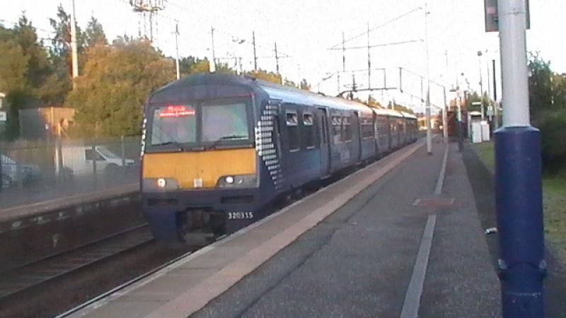 Sunny Saltire: A Spotty 320 Working To 20:13 To Milngavie Arrives At Holytown. Photo of Sunny Saltire