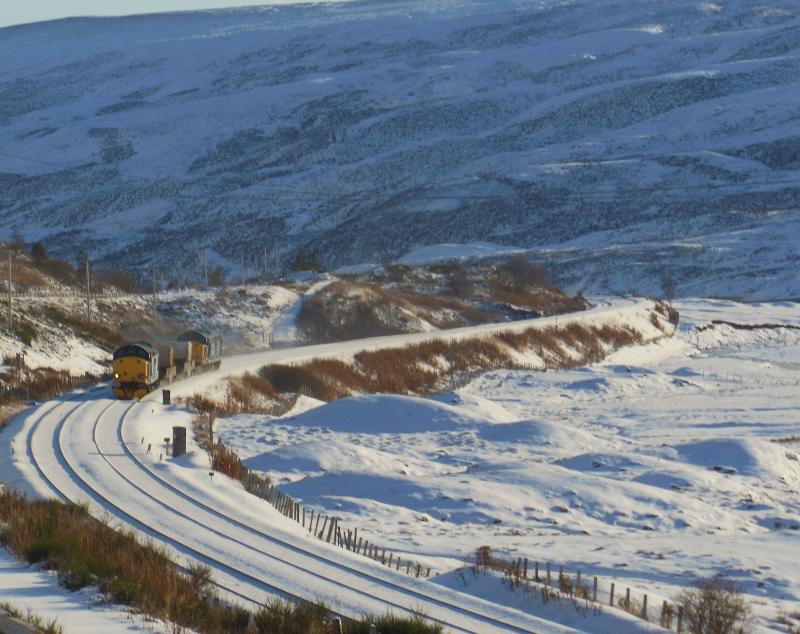 37602 37609 6S99 Carlisle Kingmoor to Georgemas Junction 05/12/12:
Climbing towards the sunny snowy summit passing Dalnaspidal and sounding and looking superb Photo of 37602 37609 6S99 Carlisle Kingmoor to Georgemas Junction 05/12/12