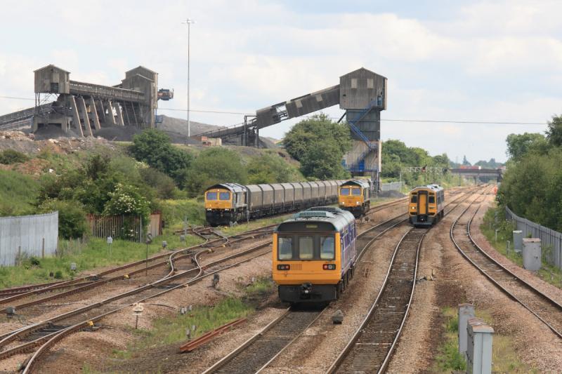 Hatfield Colliery : View of the line past Hatfield Colliery taken from the station footbridge on 08/06/09. Two local services passing 66617 waiting to take over a failed Heavyhaul coal from DBS, 66305 loading coal. Photo of Hatfield Colliery