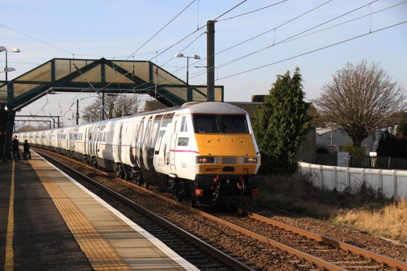 Skyfall Dvt : 007 82231 leading 91007 on the 11.30 Edinburgh to Kings Cross passing through Prestonpans watched by passengers on the opposite platform on 17/02/2013. The vinyls are the same as 91007 Photo of Skyfall Dvt