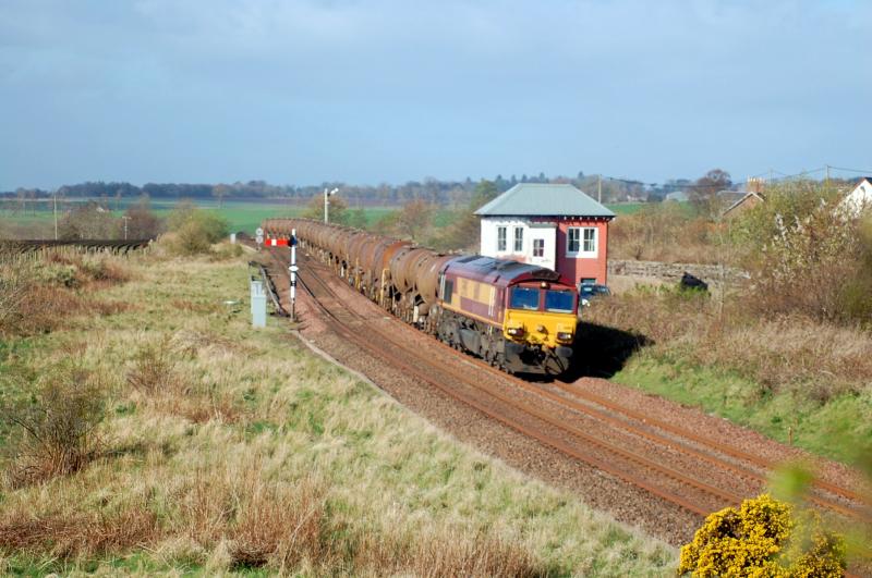 66110 at Inverkeilor: With a healthy train of 23 tanks, 66110 passes Inverkeilor SB with 6A32 Mossend - Aberdeen Waterloo on Thursday 9th May 2013. Photo of 66110 at Inverkeilor