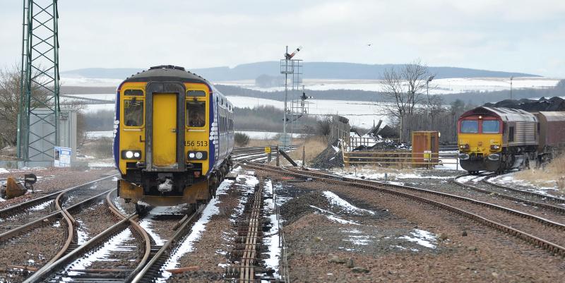 New Cumnock in winter: 1E96 the 1242 Glasgow to Newcastle at New Cumnock with 66067 in the loading point with 4S90 from Carlisle.Taken on 11th March 2013 Photo of New Cumnock in winter