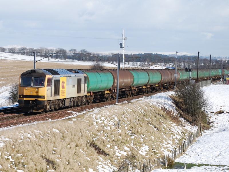 Tug in the snow: EWS 60063 heads NB on the 6S36 Dalston-Grangemouth tanks Photo of Tug in the snow