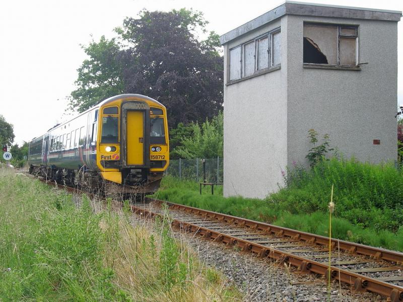 158712 at Dingwall Crossing box: On 7/7/2009, 158712 passes Dingwall Crossing signalbox with 2H81, the 09:00 Inverness - Kyle. Photo of 158712 at Dingwall Crossing box