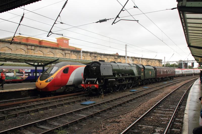 New passes Old: 390001 on 1M13 the 12.40 Glasgow Central to London Euston passing 46233 with support coach en route to Upperby to turn on 17/08/2013
Photo of New passes Old