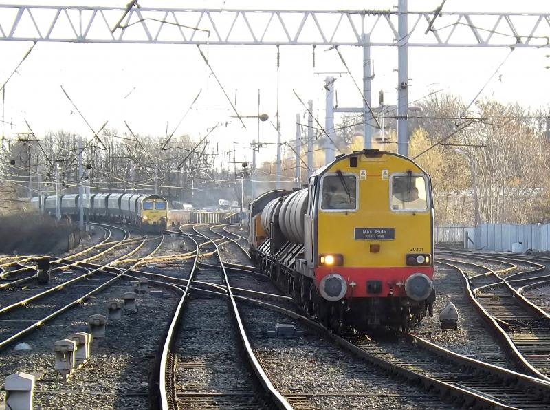 20 301: A Class 20 (20 301) leads a water tank train into Carlisle on a bright day in December 2013 while a Class 66 hauls a coal train north. Photo of 20 301
