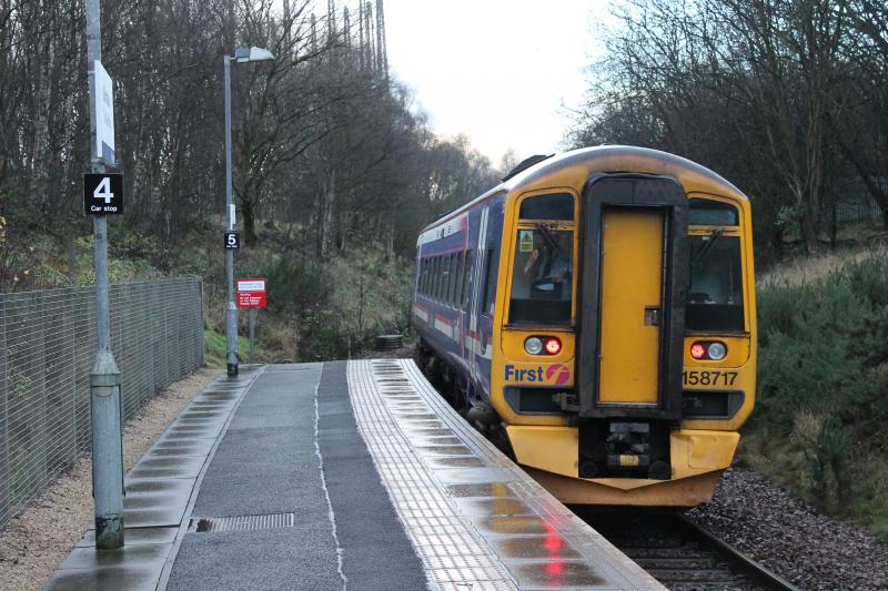 Kelvindale platform: 158717 leaves Kelvindale with the 2W67 1026 Glasgow Queen Street to Anniesland on 16 Dec 2013. Note the stop signs on the platform to provide for 4 and 5-car units in case they are ever used. Photo of Kelvindale platform