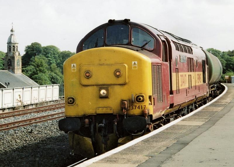 Tractor on the tankers: 9th Aug 2005 and 37417 Richard Trevithick brings 6D61 Riccarton to mossend empty oil tanks through Kilmarnock. Photo of Tractor on the tankers
