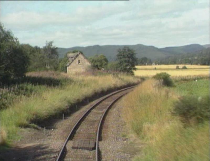 The Old Cottage at Fodderty Junction 1987: A screen shot from a driver's eye view showing the old railway cottage in between the junction at Fodderty on the Kyle of Lochalsh line. 1987 Photo of The Old Cottage at Fodderty Junction 1987