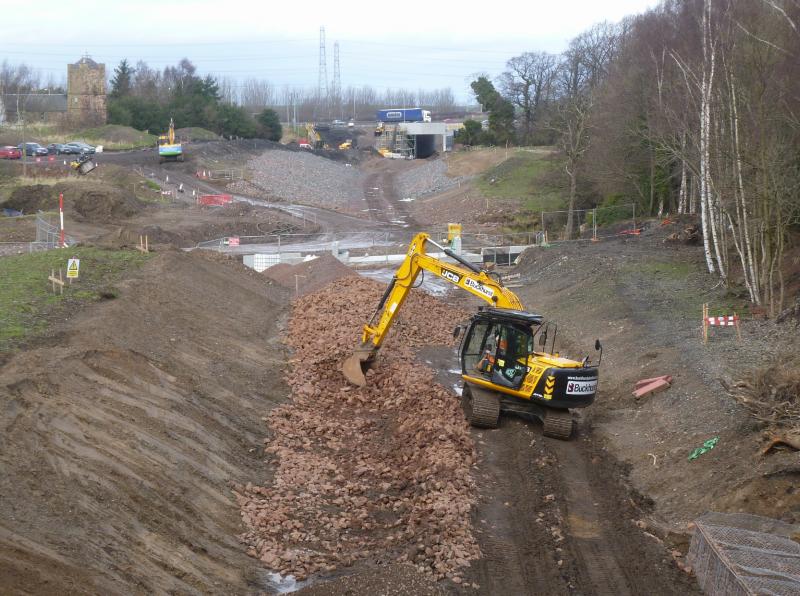 Border Railway City bypass tunnel: Drainage installation taking place near the Edinburgh city bypass with the new tunnel in the backgroundtv Photo of Border Railway City bypass tunnel