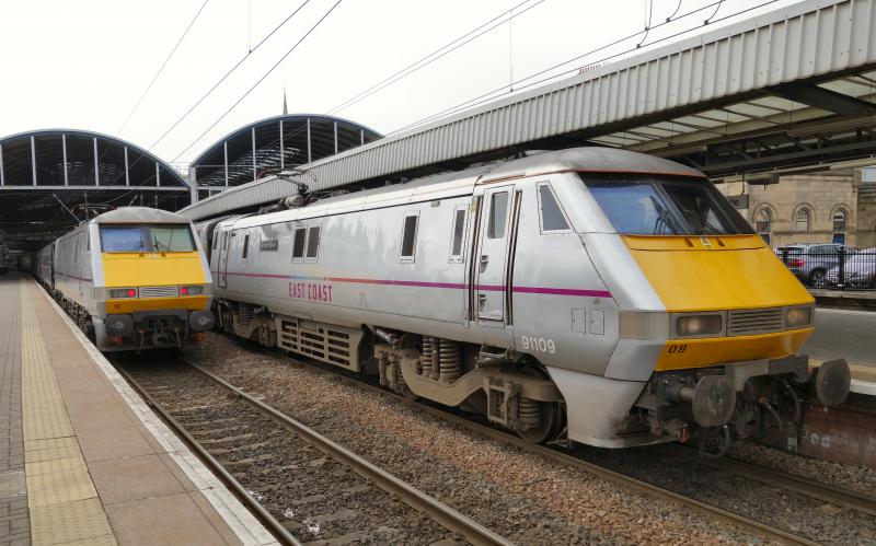 91112 & 109 at Newcastle: 91112 awaits departure with 1Y44 for Kings Cross, whilst 91109 leaves with 1S18 for Edinburgh Photo of 91112 & 109 at Newcastle