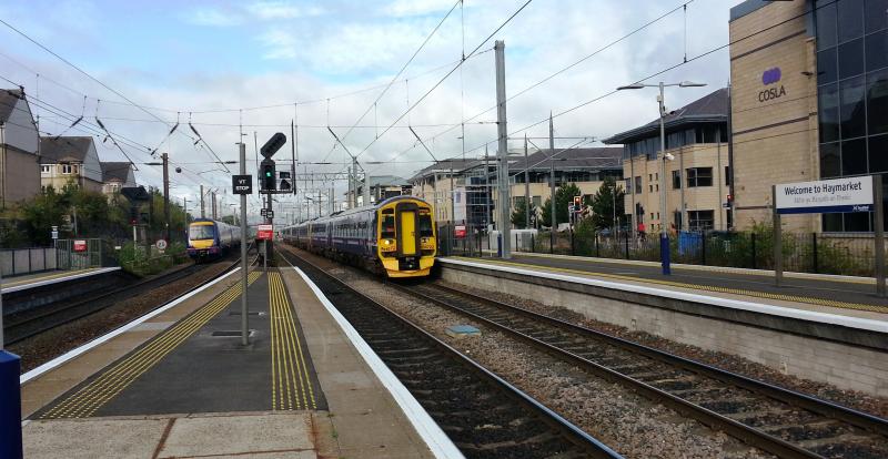 Separate Ways: 158 720 leads a rake of units into Haymarket Station on the morning of 29th July 2014 while a 170 heads west to Glasgow. Photo of Separate Ways