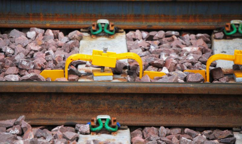 Yellow Sleeper Attachments: Clamps? fitted to sleeper on the incline to The Burma Road. These are fitted from the level at the lowest point and all the way up the incline. But what for? Photo of Yellow Sleeper Attachments