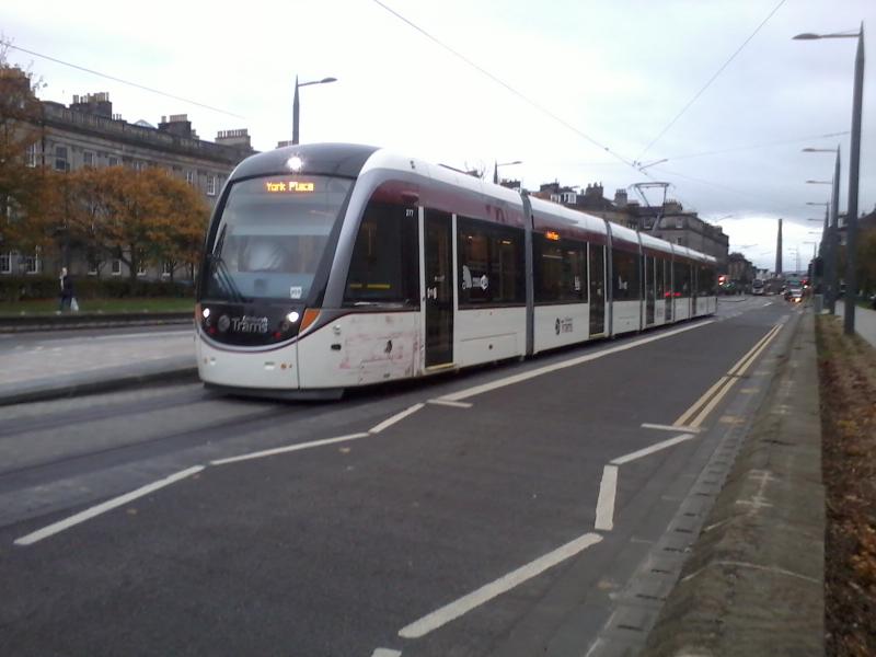 Tram 277: Tram 277 at West End Princes Street after its collision with a bus on 22/10/2014. Damage visible on the curved panel forward of the front door. Photo of Tram 277