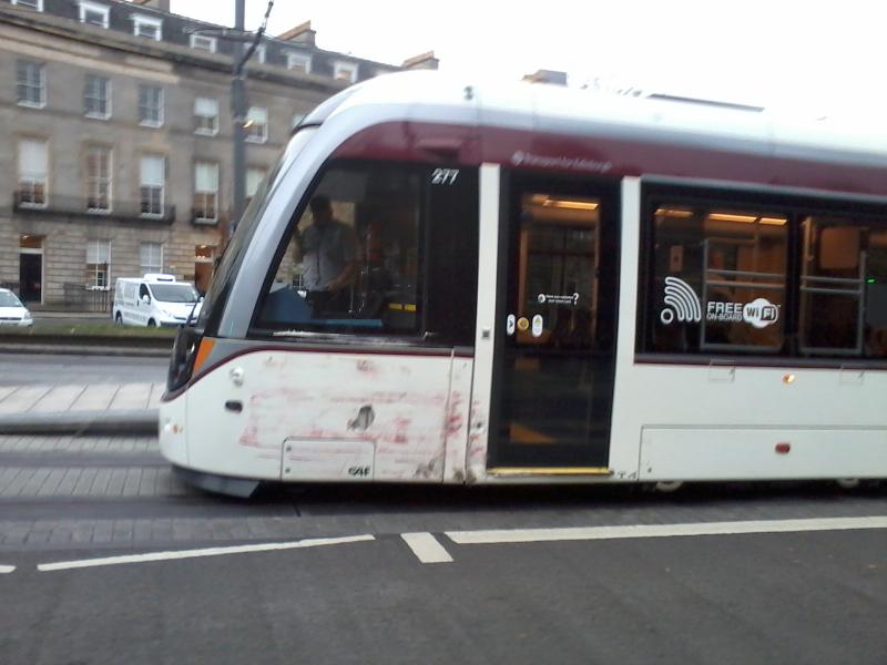Tram 277 front end: Tram 277 at West End Princes Street after its collision with a bus on 22/10/2014. Damage visible on the curved panel forward of the front door.Mobile phone photo taken in a hurry Photo of Tram 277 front end