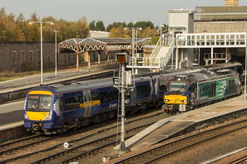 68005 at Perth: DRS 68005 'Defiant' waiting to depart Perth after rescuing failed 67007 on 3S95. Departing 1T98 170459 is leaving Perth for Glasgow QS. Photo of 68005 at Perth