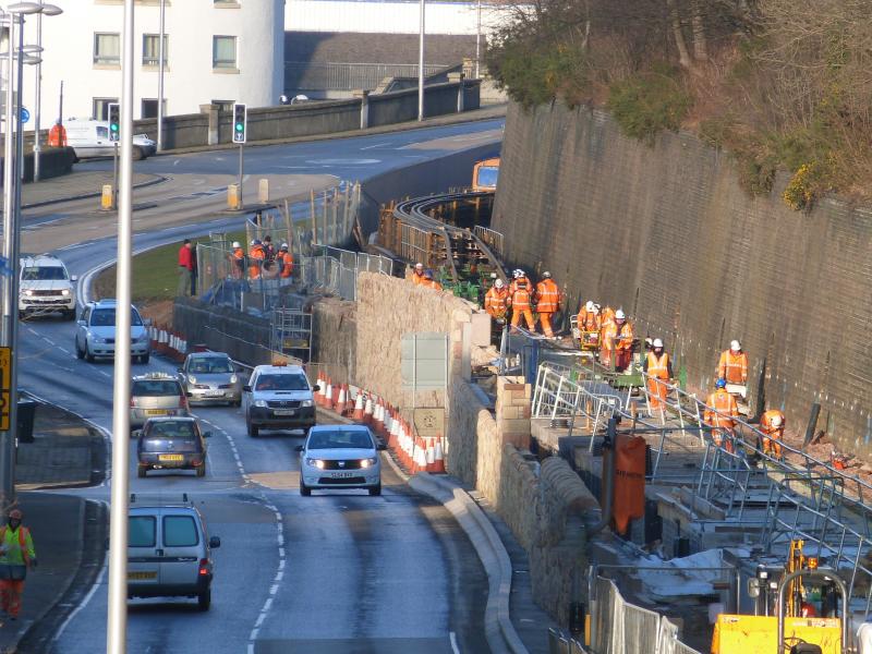 Gala Station: 66761 peeking round the corner with the rail laying train approaching the very tight layout of rail, road & Interchange at Galashiels Station. 03/02/2015 Photo of Gala Station
