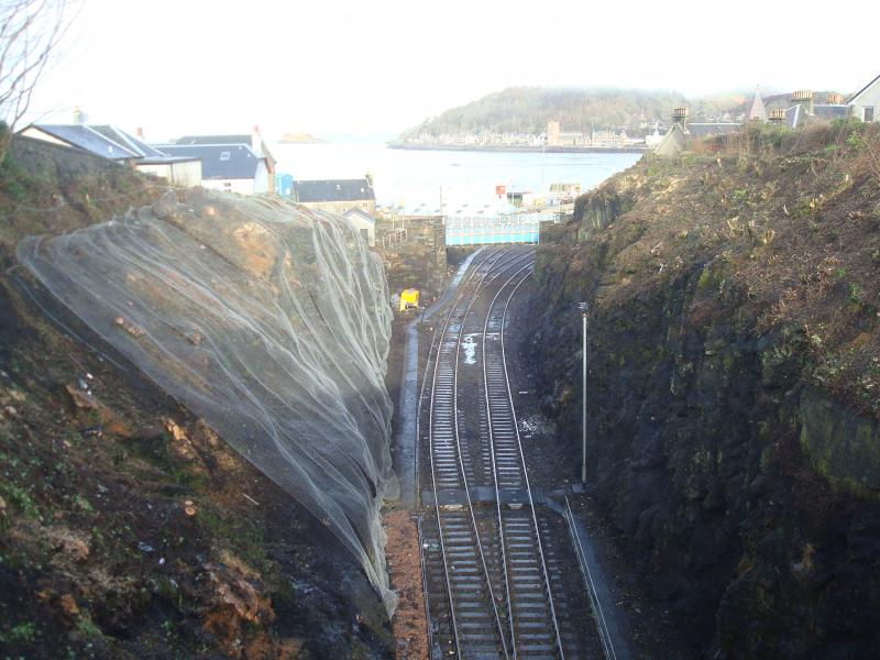 Oban Station Throat Meshing: Work currently taking place (Feb 2015) in the approach cutting to Oban Station to remove vegetation and then bolt and pin meshing. Opens up the view into Oban Bay. Photo of Oban Station Throat Meshing