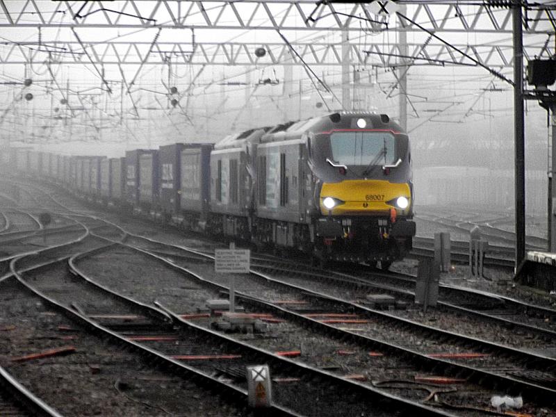 68007 and 68004 at Carlisle: Emerging from the gloom of the Misty day. DRS 68007 and 68004 arrive at Carlisle with 4S43, the Tesco Intermodal from Daventry to Mossend on Saturday 7th February 2015 Photo of 68007 and 68004 at Carlisle