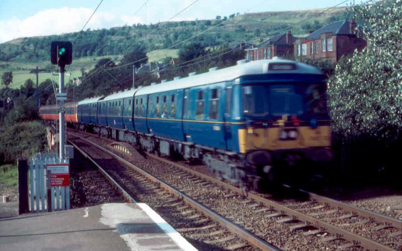303001: Painted in near original Blue Train blue livery, 303001 heads an Airdrie service arriving at Kilpatrick in 1985. Photo of 303001
