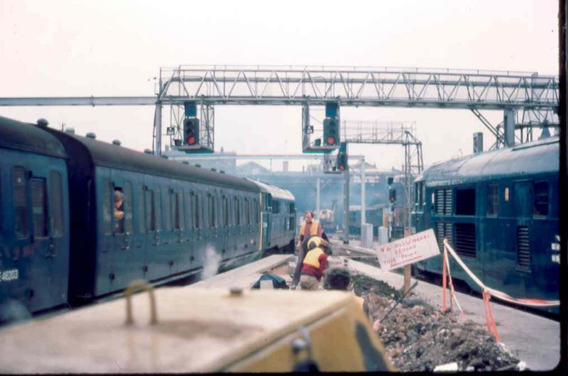Health and Safety?: Not in 1977! 31184 departing from Kings Cross in London with an evening suburban commuter train formed of (horror) slam door non corridor stock amongst the debris of reconstruction work for the ECML electrification. Photo of Health and Safety?
