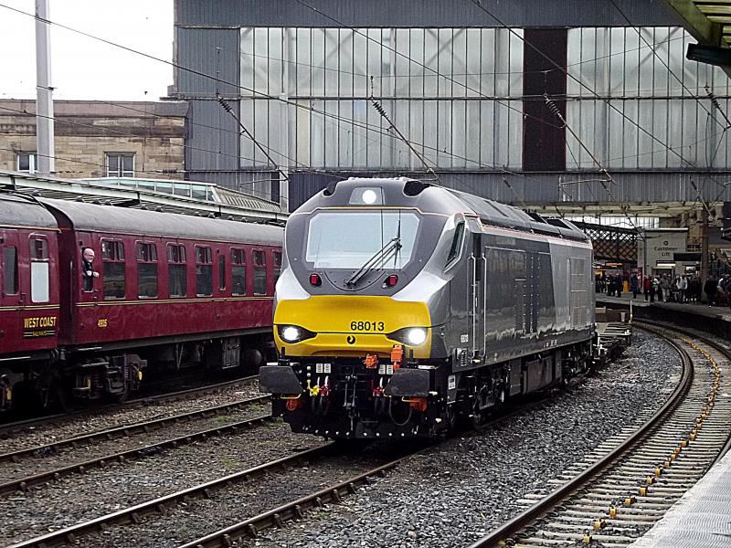 68013 at Carlisle: DRS operated, but in Chiltern colours 68013 waits at Carlisle with 4Z44. An empty intermodal wagon move from Motherwell to Crewe on Saturday 7th March 2015. Photo of 68013 at Carlisle
