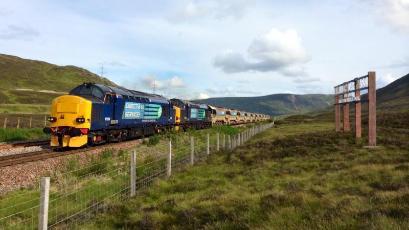 37259 + 37602 Ballast at Druimuachdar Summit:
Pair of DRS tractors cresting Druimuachdar Summit with ballast for the Far North Line during July 2014 Photo of 37259 + 37602 Ballast at Druimuachdar Summit