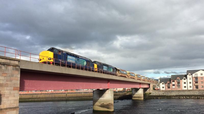 37259 + 37602 Ness Bridge July 2014:
DRS tractors power over Ness Bridge Inverness heading for Achnasheen in July 2014 Photo of 37259 + 37602 Ness Bridge July 2014