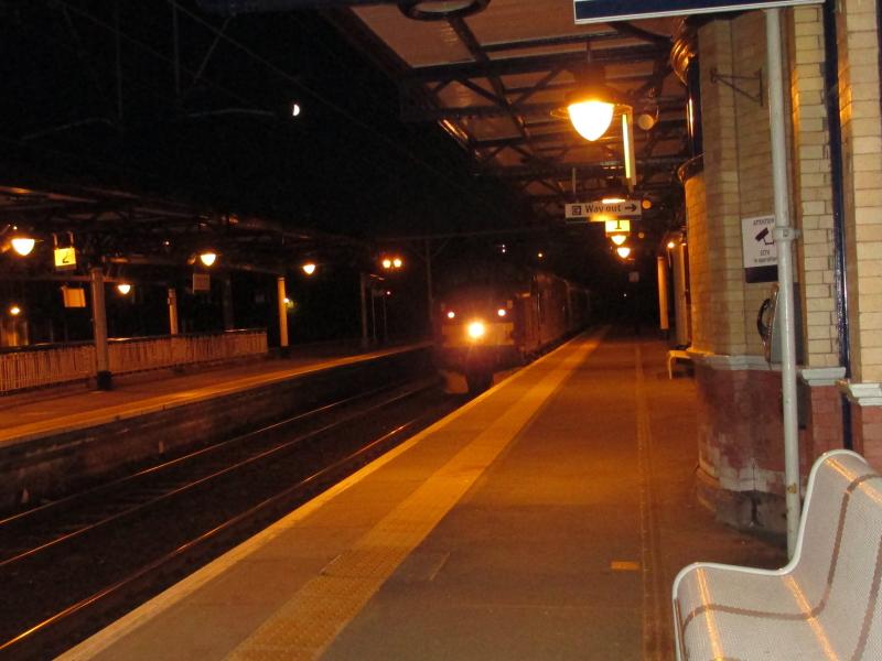 WCRC Class 37#37516 Dumbarton Central 23 June 2015: WCRC 37516 slows for the Dumbarton Central stop with the Euston Bound sleeper on 23 June 2015 with Class 67#67009 on rear for ETH duties Photo of WCRC Class 37#37516 Dumbarton Central 23 June 2015