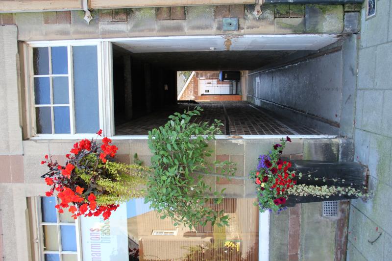 Track in Melrose : Rails laid through the 'close' * of a building, now housing 'Marmion's Brasserie', on the Square at Melrose. (* Sc. = passageway into, or through) Photo of Track in Melrose