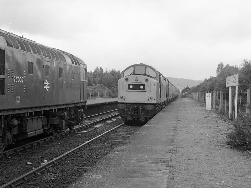 40157: As 26007 waits with its PW train, 40157 rumbles into Carrbridge on 5 July 1978 with the 10.35 Glasgow Queen Street - Inverness. Photo of 40157