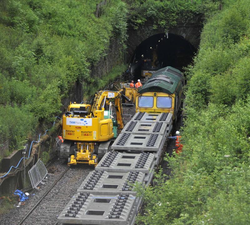 Track Panels For QS Tunel Down Side: The new track panels for the Queen Street Down side Tunnel wait to be unloaded by TXM 4583. 66597 brought the train in and was tailed by 66956 from Leith South Photo of Track Panels For QS Tunel Down Side