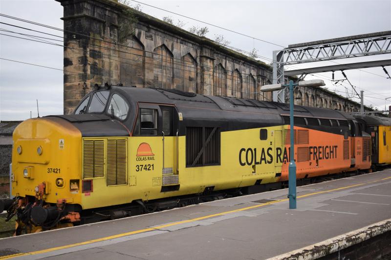 Colas 37421 leads test train out of Carlisle: Colas 37421 TnT with 37057/D6757 withe Network Rail test train leaves Platform 1 at Carlisle with the 16.55. High Wapping Sidings - Blackpool. Photo of Colas 37421 leads test train out of Carlisle